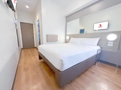 a bedroom with a large white bed in a room at Red Planet Manila Aseana City in Manila