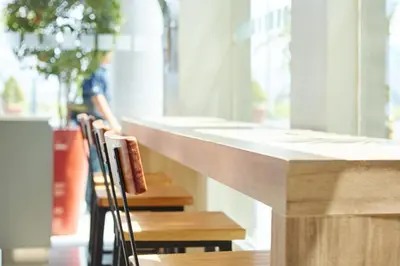 a row of chairs sitting at a counter in a restaurant at Red Planet Manila Aseana City in Manila