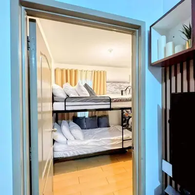 a reflection of a room with two bunk beds at Amari Homestay @ Sorrento Oasis Condominium in Manila