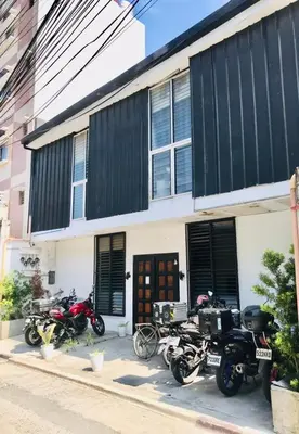 a group of motorcycles parked in front of a building at Budget Transient Capsule Room Mirasol Near BGC in Manila