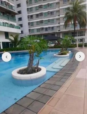 a swimming pool with two trees in a building at My Quiet Place at The Beacon - Makati City in Manila