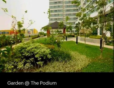 a garden o the podium with a building in the background at My Quiet Place at The Beacon - Makati City in Manila