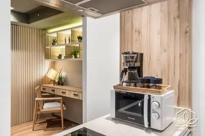 a kitchen with a coffee maker on top of a stove at Vibrant Oasis with the best view + Fast WiFi in Manila
