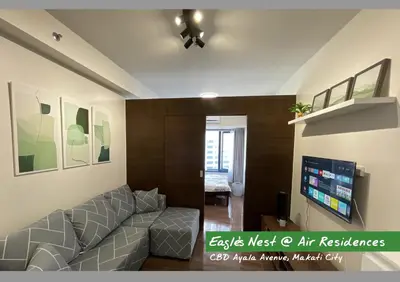 a living room with a couch and a flat screen tv at City View Condo Unit with Netflix & Wifi in Ayala Avenue Makati City in Manila