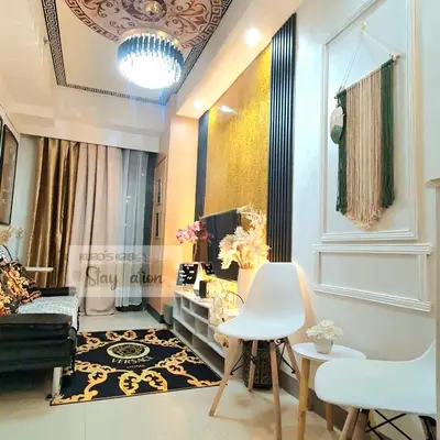 a living room with a couch and a table and chairs at Condo in Pasay S Residences in Manila