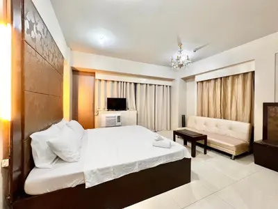 a bedroom with a bed and a living room at Kiel 5-Star Condo Hotel Across NAIA Manila Airport Terminal 3 in Manila