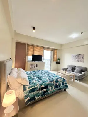 a bedroom with a bed and a couch at Kiel 5-Star Condo Hotel Across NAIA Manila Airport Terminal 3 in Manila