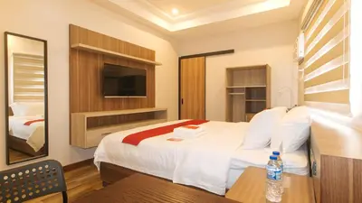 a hotel room with a bed and a television at RedDoorz Plus @ Bez Tower and Residences San Juan in Manila