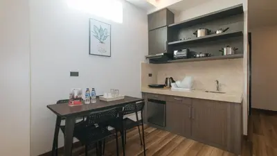 a small kitchen with a table and a sink at RedDoorz Plus @ Bez Tower and Residences San Juan in Manila