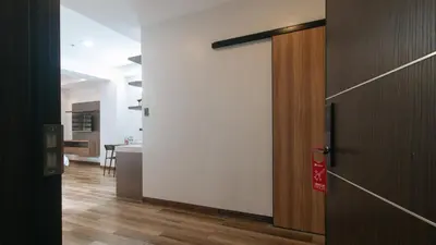an open door to a room with a kitchen at RedDoorz Plus @ Bez Tower and Residences San Juan in Manila