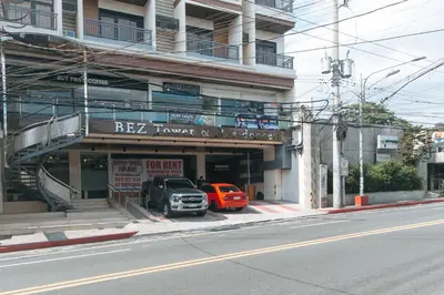 two cars parked in front of a building at RedDoorz Plus @ Bez Tower and Residences San Juan in Manila