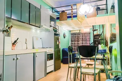 a kitchen with a table and chairs in a room at Casa Jessica 329 Dubai style One bedroom Corner unit in Bacoor
