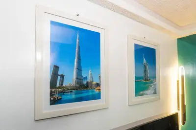 two framed photographs of the dubai skyline on a wall at Casa Jessica 329 Dubai style One bedroom Corner unit in Bacoor