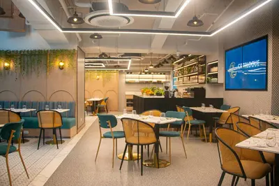 a restaurant dining room with tables and chairs at Citadines Benavidez Makati in Manila