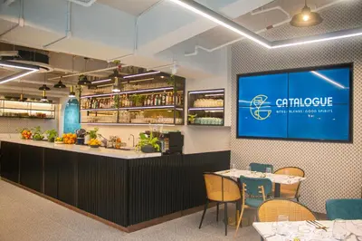 a restaurant with a bar with a tv on the wall at Citadines Benavidez Makati in Manila