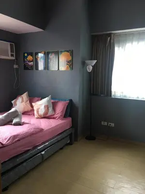 a bedroom with a bed with pink sheets and a window at Simple & Cozy 1 Bedroom US Embassy, Roxas Blvd, Ermita, Manila in Manila