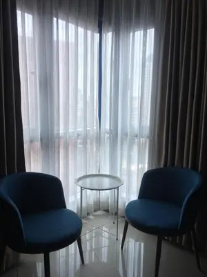 two chairs and a table in front of a window at Simple & Cozy 1 Bedroom US Embassy, Roxas Blvd, Ermita, Manila in Manila