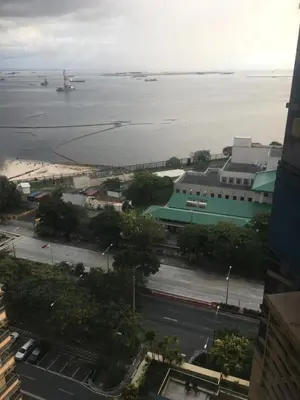a view of the ocean from a building at Simple & Cozy 1 Bedroom US Embassy, Roxas Blvd, Ermita, Manila in Manila