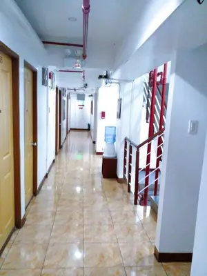 a hallway of an office building with a long corridor at Makati Poblacion Hotel in Manila