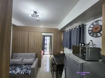 a living room with a couch and a microwave at SMDC Shore 2 Minimalist Home in Manila