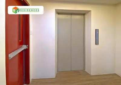 an elevator door in a building with a sign on it at UN Residences in Manila