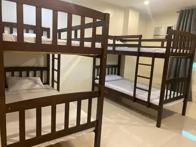 a group of bunk beds in a room at ABE Lodge Taguig in Manila