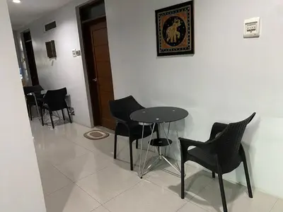 a row of chairs and a table in a room at ABE Lodge Taguig in Manila