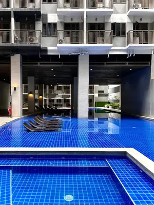 a swimming pool in the middle of a building at Evan Suite S Residences T1 in Manila