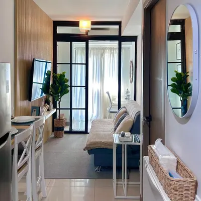 a living room with a couch and a table at Evan Suite S Residences T1 in Manila