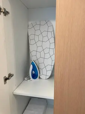 a vase sitting on a shelf in a room at Cozy 1 BR One Uptown Residences BGC in Manila