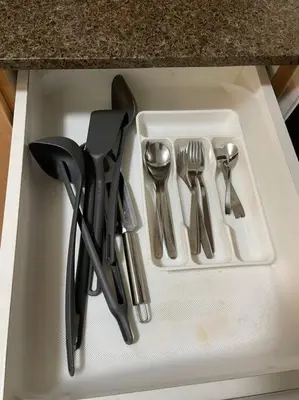 a white tray with utensils sitting on a counter at Cozy 1 BR One Uptown Residences BGC in Manila