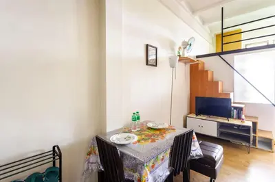a room with a table with plates on it at Casa Jessica 326 Heavens Place One bedroom plus loft Condo Unit in Bacoor