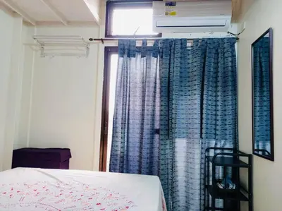 a bedroom with a bed and a window with curtains at Casa Jessica 326 Heavens Place One bedroom plus loft Condo Unit in Bacoor