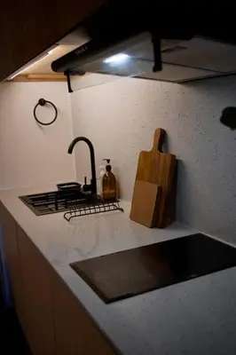 a kitchen counter with a sink and a stove at Nuvali Laguna Amaia 2BR free parking @ The Sanctuary near Tagaytay and Carmelray Industrial Park in Numero Dos