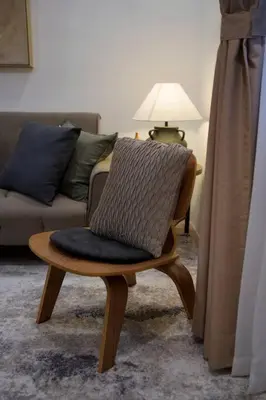 a chair with a blanket on it in a living room at Nuvali Laguna Amaia 2BR free parking @ The Sanctuary near Tagaytay and Carmelray Industrial Park in Numero Dos