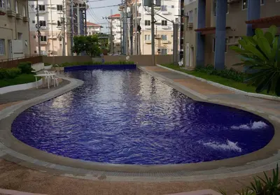 a large blue pool in the middle of a building at Nuvali Laguna Amaia 2BR free parking @ The Sanctuary near Tagaytay and Carmelray Industrial Park in Numero Dos