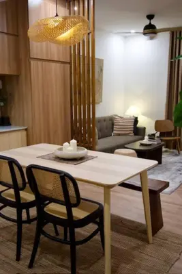 a dining table and chairs in a living room at Nuvali Laguna Amaia 2BR free parking @ The Sanctuary near Tagaytay and Carmelray Industrial Park in Numero Dos