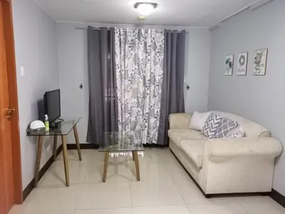 a living room with a couch and a table at 1BR Condo at Montecito Newport City Residential Resort across NAIA and Marriott Hotel in Manila