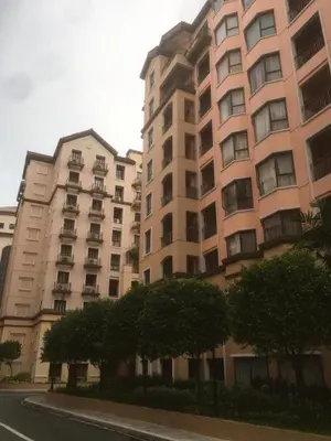 a large apartment building with trees in front of it at 1BR Condo at Montecito Newport City Residential Resort across NAIA and Marriott Hotel in Manila