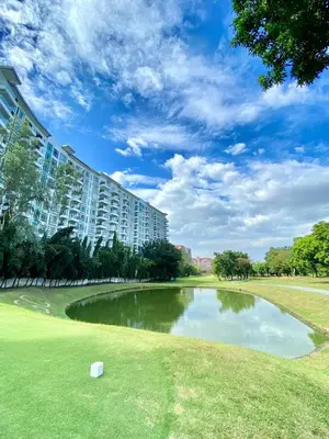 a pond in front of a large building at 1BR Condo at Montecito Newport City Residential Resort across NAIA and Marriott Hotel in Manila