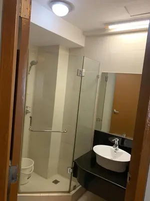 a bathroom with a glass shower and a sink at 1BR Condo at Montecito Newport City Residential Resort across NAIA and Marriott Hotel in Manila