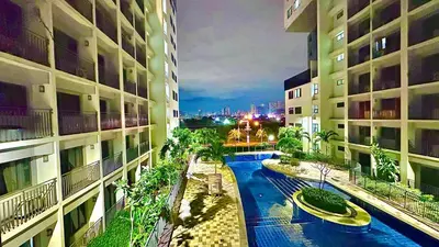a view of a swimming pool between two buildings at Mall of Asia Shore 2 Condo in Manila