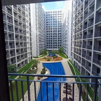 a view from the balcony of a apartment building with a pool at Mall of Asia Shore 2 Condo in Manila
