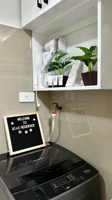 a kitchen with a counter top with a phone on top of a microwave at Mall of Asia Shore 2 Condo in Manila