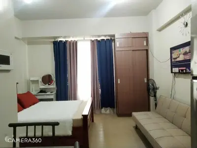 a bedroom with a bed and a couch in a room at Pasay Condotel near NAIA terminal 3 (3 mins walk in) in Manila