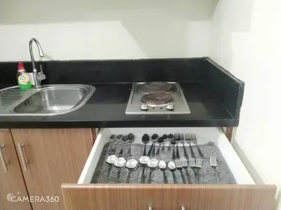a kitchen counter with a sink and a stove at Pasay Condotel near NAIA terminal 3 (3 mins walk in) in Manila