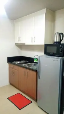 a kitchen with a refrigerator and a microwave at Pasay Condotel near NAIA terminal 3 (3 mins walk in) in Manila