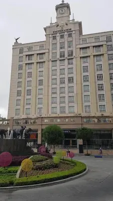 a large building with a clock tower on top of it at Pasay Condotel near NAIA terminal 3 (3 mins walk in) in Manila