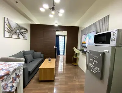 a living room with a couch and a table at Air Residences with Fast Wifi in Manila