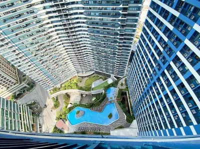 an aerial view of a large building with a pool at Air Residences with Fast Wifi in Manila
